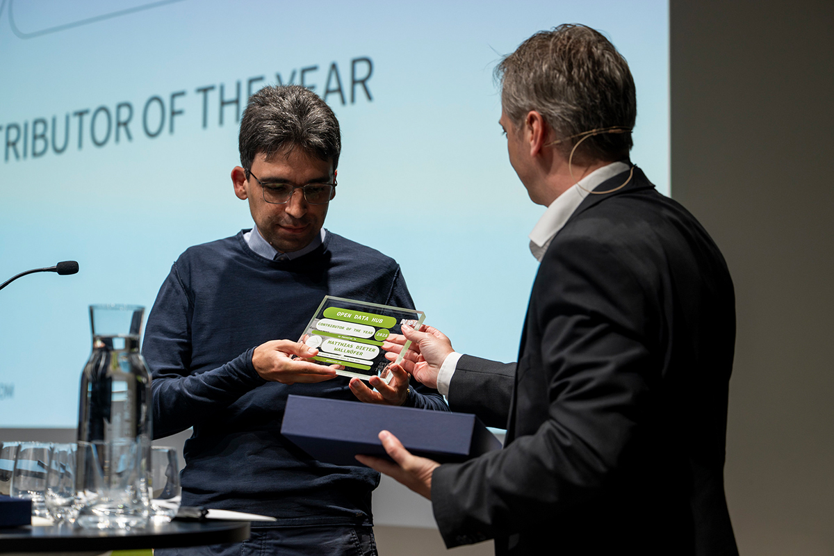 Award ceremony at Open Data Hub Day 2025 showing the presentation of the Contributor of the Year award, highlighting recognition and community spirit.