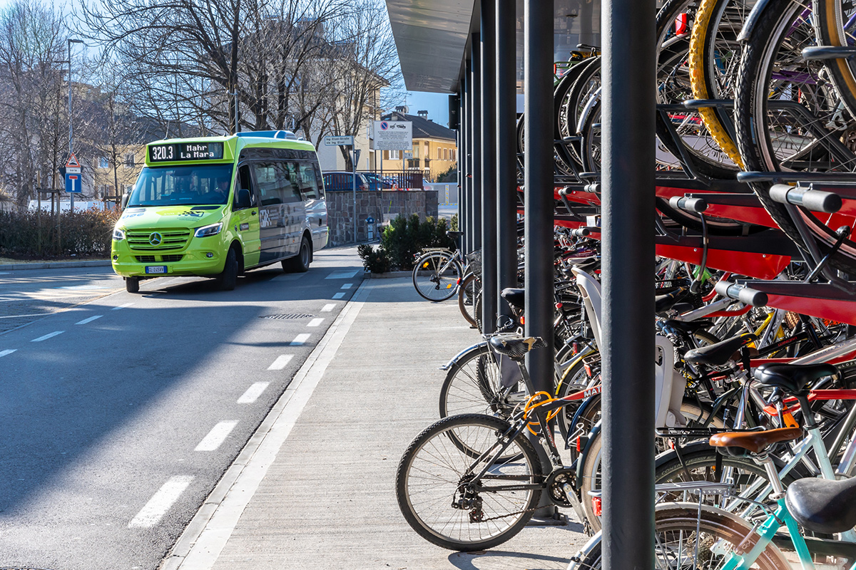 Public bus and bike parking in an urban mobility hub, illustrating MaaS4Italy’s goal of seamless multimodal transport integration.