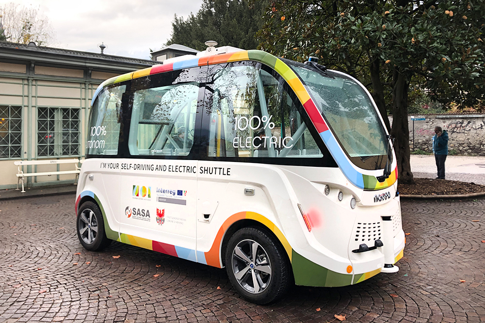 Photograph of Merano residents participating in the MENTOR project's mobility service trials, emphasizing community involvement.