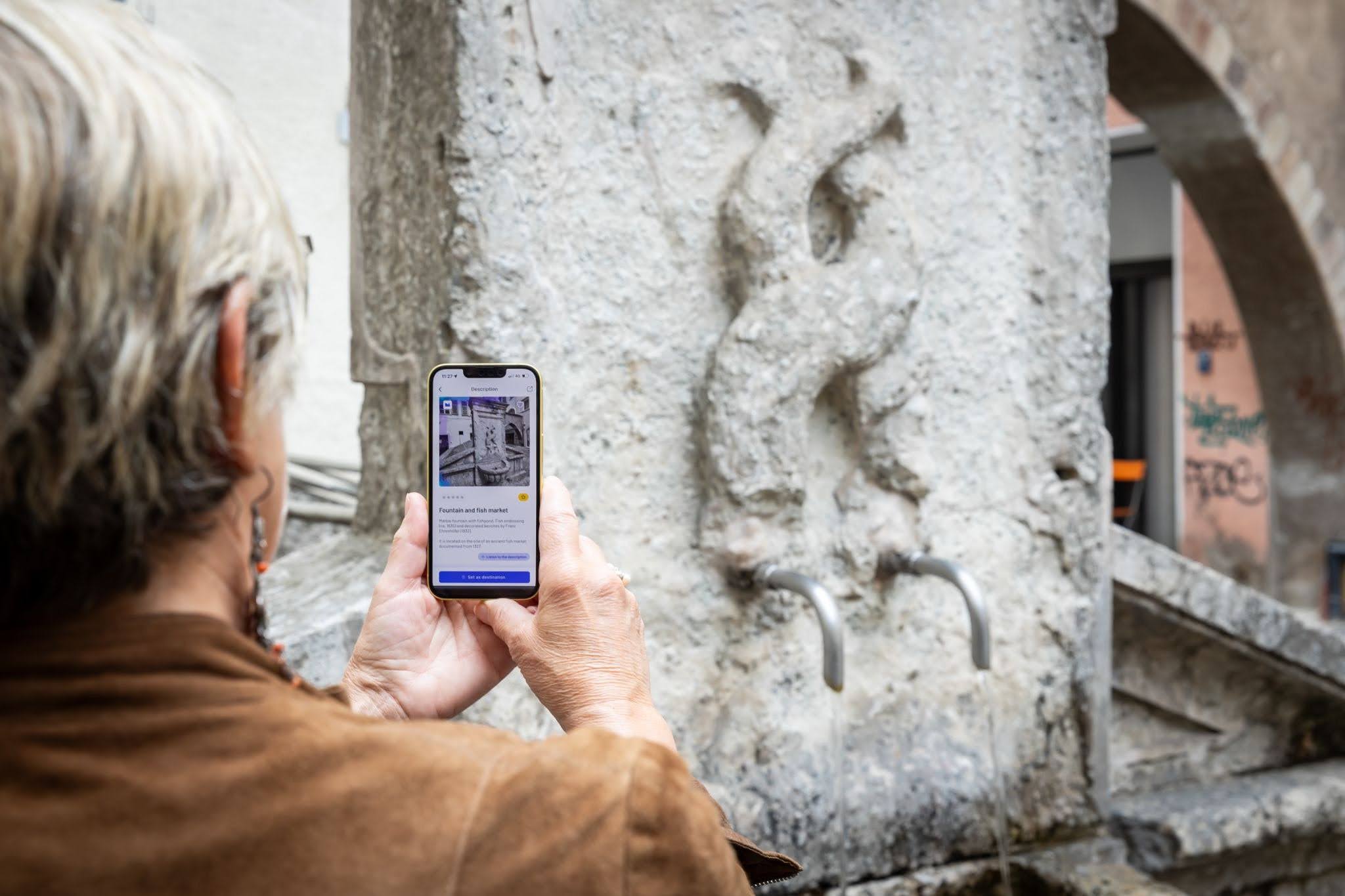 User exploring cultural places with the Stendhapp app, supported by Open Data Hub datasets for tourism discovery.