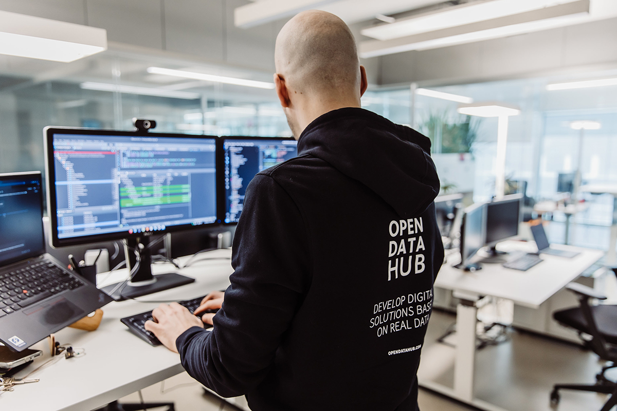 Developer working with Open Data Hub tools in a modern office, creating digital solutions based on real-world open data and tourism datasets.